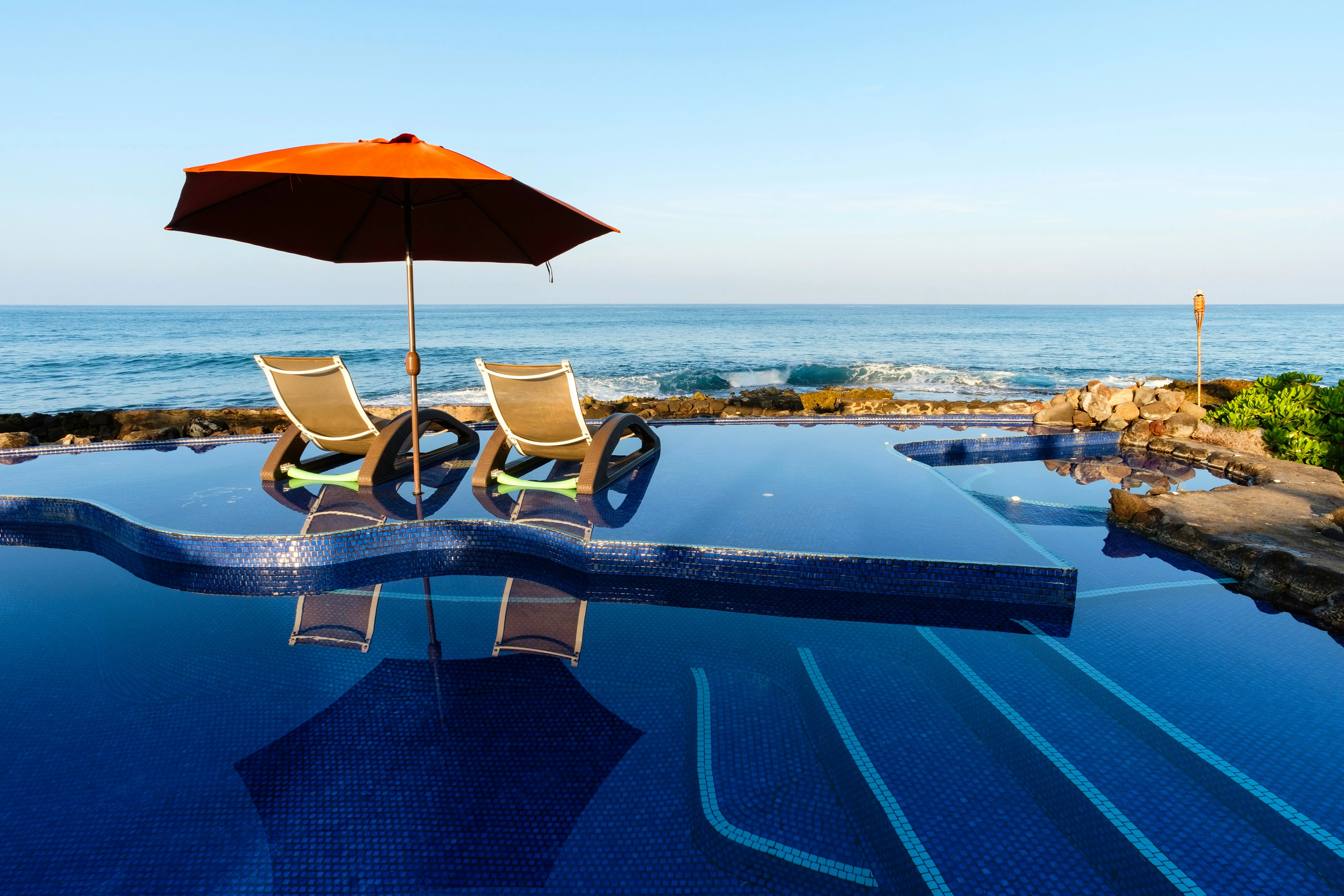 An infinity pool above the Pacific at golden hour
